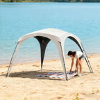 Den Premium Canopy — woman setting up on sandy beach lakeside